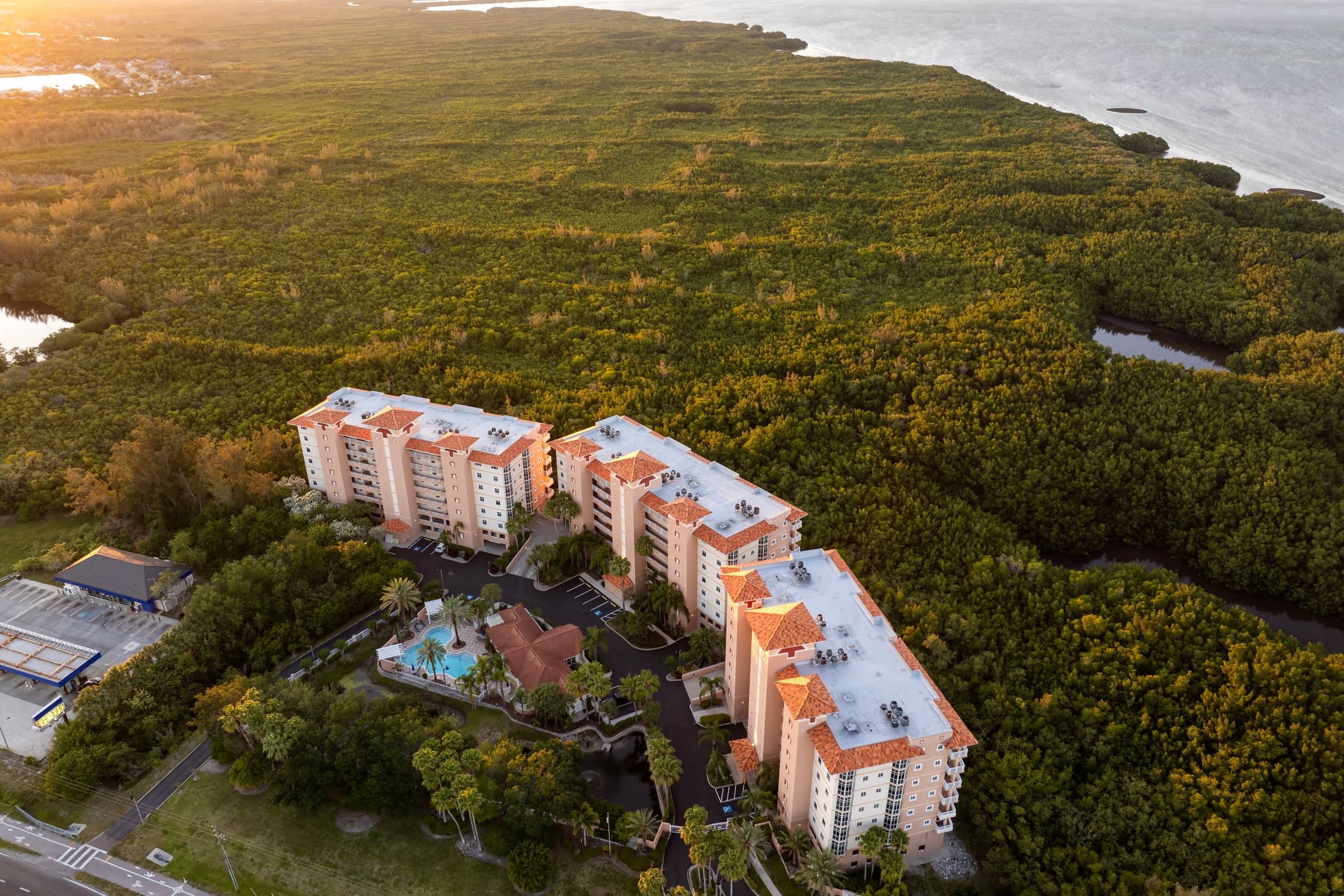 apartment building with tropical wetlands view in florida rural area. family housing in quiet neighborhood. real estate development in american suburbs